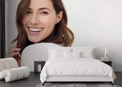 closeup portrait of young happy woman looks in camera Wall mural