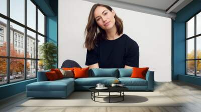 Portrait of a young happy woman smiling, looking beautiful and elegant. Looking in camera while isolated on white background.  Wall mural