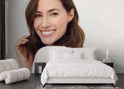 portrait of beautiful naturally brunette woman, smiling and looking in camera with white teeth. clos Wall mural