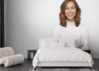 portrait of young happy woman looks in camera Wall mural