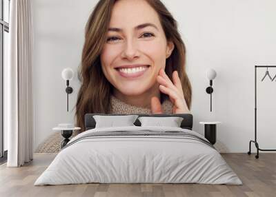 Portrait of young happy woman smiling on white background while looking in camera. Big smile on her face, looking beautiful and cute.  Wall mural