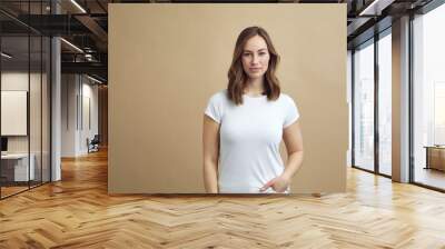 portrait of young woman looking confident at the viewer on a nice modern color background Wall mural