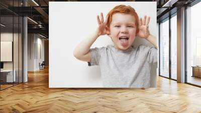 Redhead child and boy being silly and having fun in front of camera, showing silly face and emotions  Wall mural