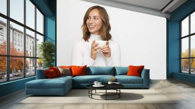 young woman with cup of coffee looks left Wall mural