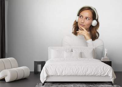 young woman with headphones  looks left Wall mural