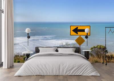 Turn left sign and the pacific ocean Wall mural