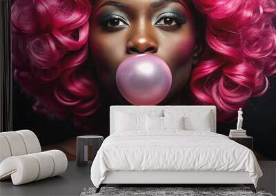 African American female with vivid make up inflates a bubble of gum on a pink background. Wall mural