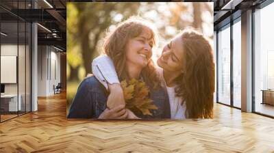 Daughter hugging her mother - autumn season Wall mural