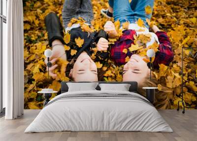 Friends having fun in leaves Wall mural