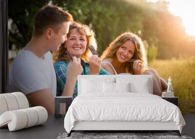 Happy caucasian family eating chocolate bar together Wall mural