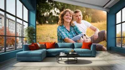 Outdoor portrait of smiling mother with adult son Wall mural