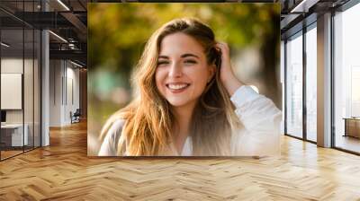 Teen model brushing hands through her hair Wall mural