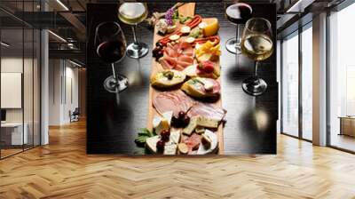 Wine and charcuterie and cheese board with a place for text. Prosciutto di Parma ham, blue cheese. Italian appetizers or antipasto set with gourmet food on table top view. Mixed delicatessen Wall mural