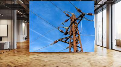 Energy concept. Ecological energy.Old rusty electricity poles and wires in rural field. Wall mural