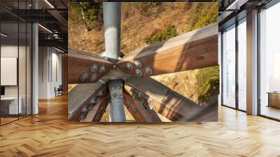 Wooden beams with screws in the structure. Assembling and connecting wooden beams. Detail of building connections. The construction of the observation tower. Wall mural