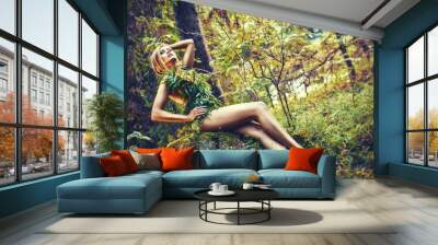 beautiful blonde woman with leaves dress in nature, glamour and fashion photography in summer Wall mural