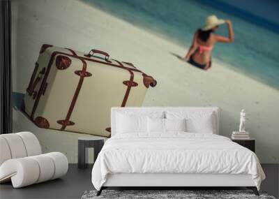 beautiful woman on white beach with travel accessories, exotic vacation, product photo for travel agency Wall mural