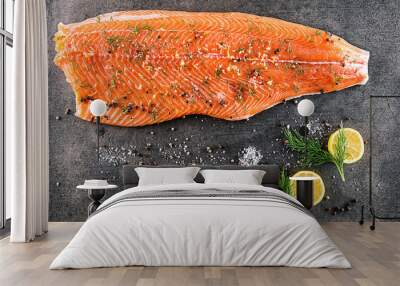 raw salmon fish steak with ingredients like lemon, pepper, sea salt and dill on black board, modern gastronomy in restaurant  Wall mural