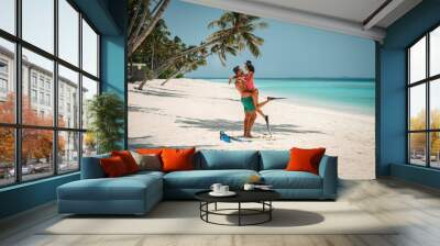 young attractive couple with snorkeling gear, couple enjoy snorkeling in the ocean, coral watching and active vacation Wall mural