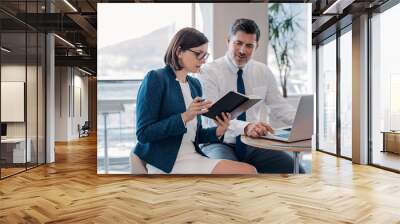 Discussing business together in the office Wall mural