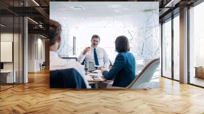 Discussing strategy with his team Wall mural