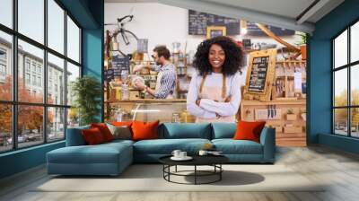 Smiling young African American female barista standing in her cafe Wall mural