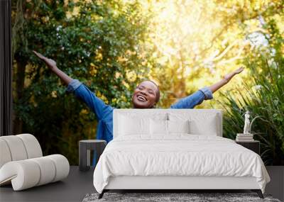 Smiling young African American woman embracing a sunny summer day Wall mural