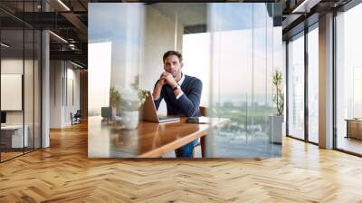 Young businessman deep in thought while working from home Wall mural