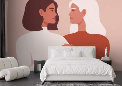 Beautiful senior mother and her adult daughter are embracing and looking at each other in the face. The concept of motherhood, friendship, care and love. Wall mural