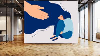 human hand helps a sad lonely woman to get rid of depression. a young unhappy girl sits and hugs her Wall mural