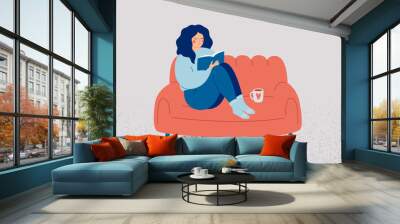 Woman reading book at home in the evening. Happy female person resting on comfy sofa with literature and coffee. Relaxation and care self time concept. Mental wellbeing vector illustration Wall mural