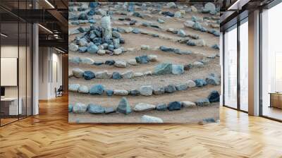 Traditional natural stone walking labyrinth maze made for contemplation and worship, created with rocks in shades of blue and turquoise. Wall mural