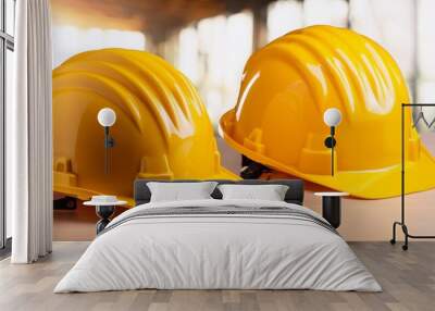 two yellow hard hats are on a table Wall mural