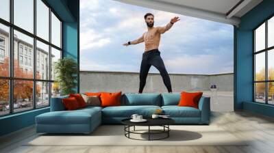 attractive hansome man with athletic strong body doing morning yoga asana outdoors Wall mural