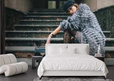 stylish woman in winter fur coat walking in street Wall mural