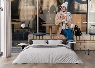 stylish woman walking in winter street Wall mural