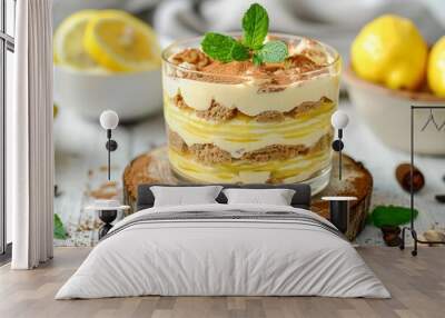 lemon tiramisu no-bake layered summer dessert in a glass on wooden round block on white wooden background  Wall mural