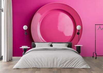 Pink plate isolated on a vibrant magenta background  Wall mural