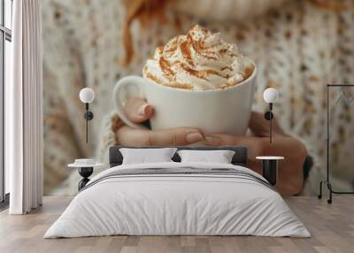 Woman holding cup of tasty pumpkin spice latte with whipped cream at white table, closeup Wall mural