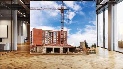 Tower crane on construction site on blue sky background Wall mural