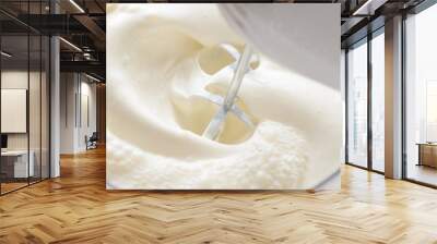 Whipping cream with a mixer. Bubbles on cream Wall mural