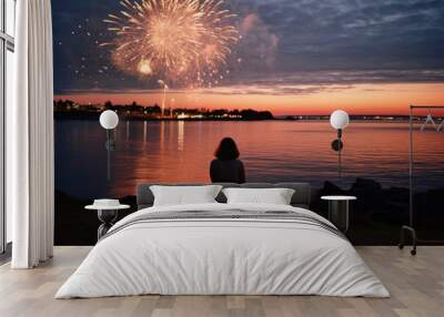 silhouette of a woman standing with her back by the water to watch sky full of fireworks on new years eve/4th of July/party/celebration alone/solitude in magazine cover editorial textured film look Wall mural