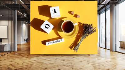 Calendar for November 1: cubes with numbers 0 and 1, the name of the month in English, a cup of tea, two pieces of sugar in the shape of a heart, a bouquet of lavender, shadows from objects Wall mural