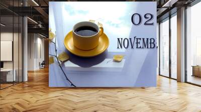 Calendar for November 2: numbers 02, name of the month, yellow November mug, autumn leaves on a pastel background Wall mural