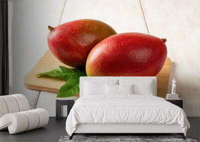 two red ripe palmer mangoes on a cutting board over white wooden table. ready to eat whole sweet tas Wall mural