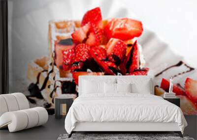 Belgium waffers with sugar powder, strawberries and chocolate on ceramic plate on white table. Wall mural