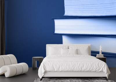 A stack of books on a classic blue background. Wall mural