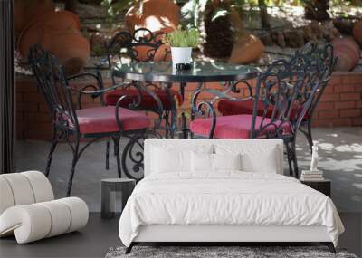 Forged table and chairs in a street cafe in Antalya, Turkey. Cozy place in the shade to relax Wall mural