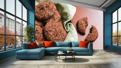 Homemade chocolate oatmeal cookies with white and black sesame seeds on a brown wooden table Wall mural