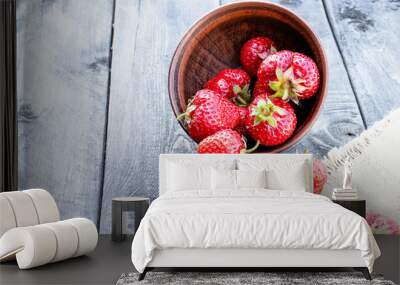 ripe red strawberries scattered on a table on burlap. Wall mural